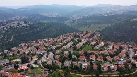 aerial view of a residential neighborhood in a hilly forested landscape