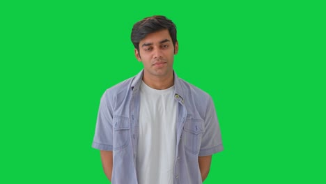 curious indian young boy listening to someone green screen