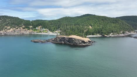 rising aerial shot of washington state's tree lined coast