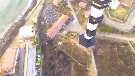 Drone-shot-Moving-up-a-modern-lighthouse-located-in-Pondichery,-India