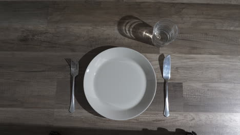 table setting with knife, fork, plate and glass