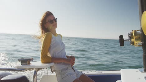 side view of a teenage caucasian girl enjoying her time on a boat