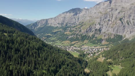 drone slowly flying towards a quiet mountain town in switzerland