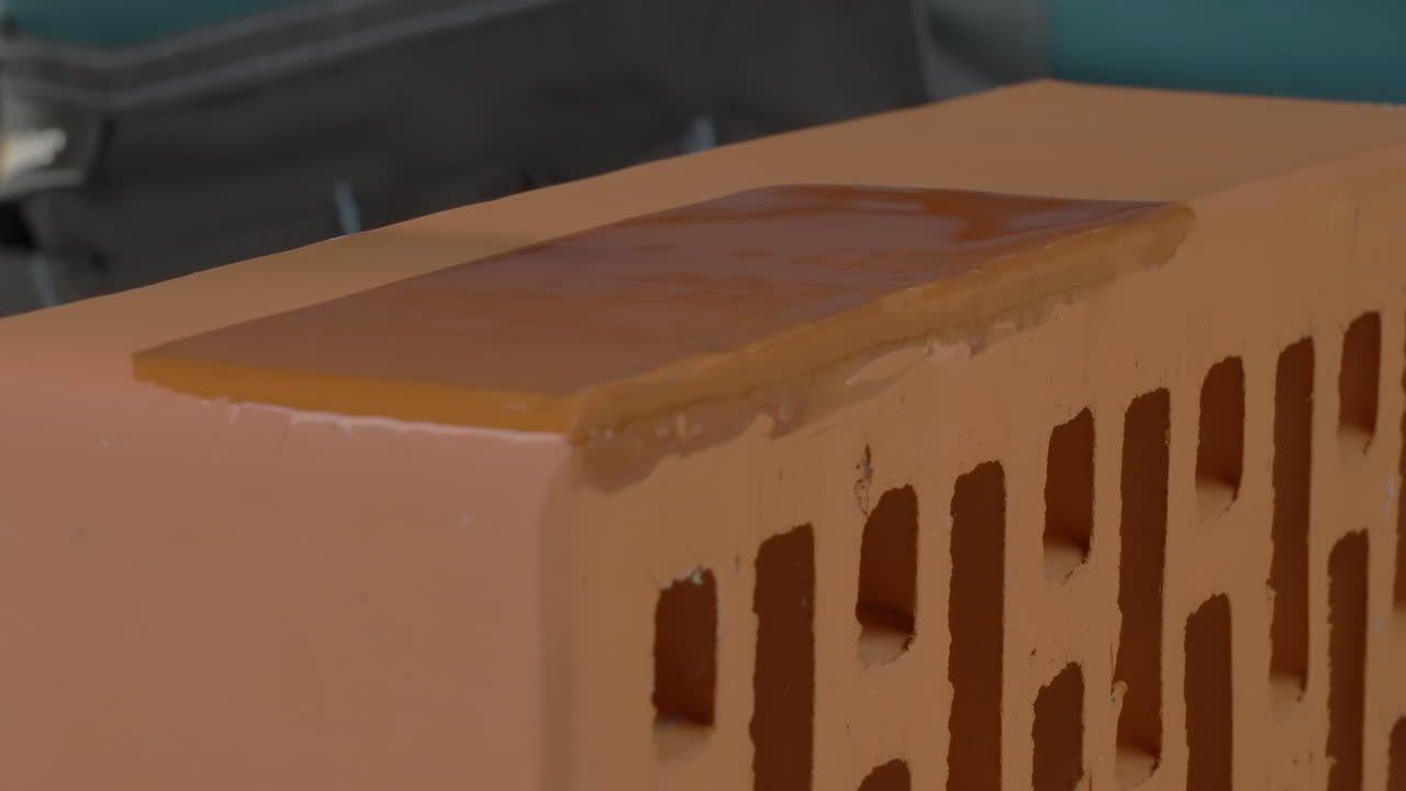Applying protective coating to a brick