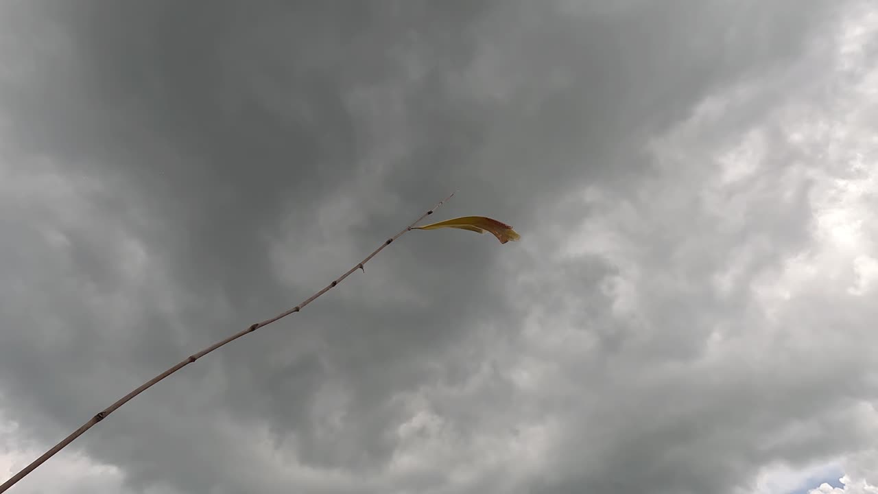 Rustic Wind Direction Flag During Cloudy Day In Wat Tham Suea (Tiger Cave Temple) Thailand. Low Angle Shot