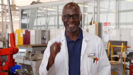 Portrait-Of-Male-Engineer-Walking-Towards-Camera-In-Workshop