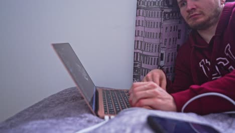 a young phd candidate pages past pages of important research for his project online