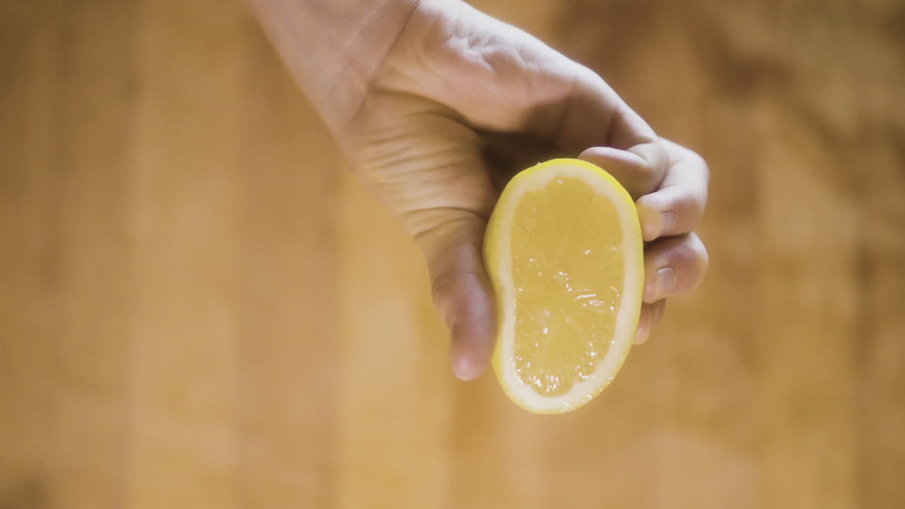 Hand holding a lemon slice