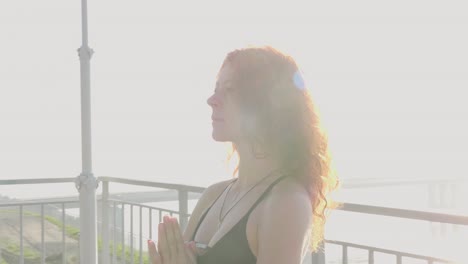 woman in yoga pose on balcony