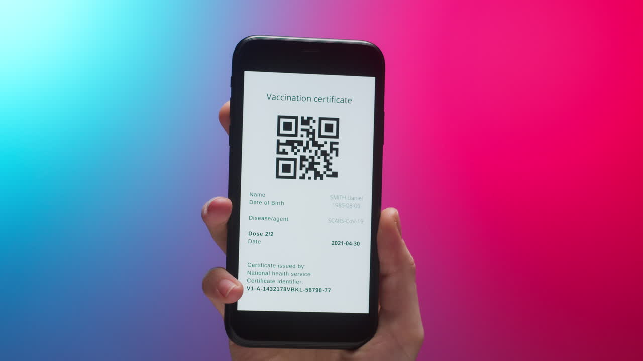 Hand Holding Smartphone Displaying Digital Vaccination Certificate with QR Code
