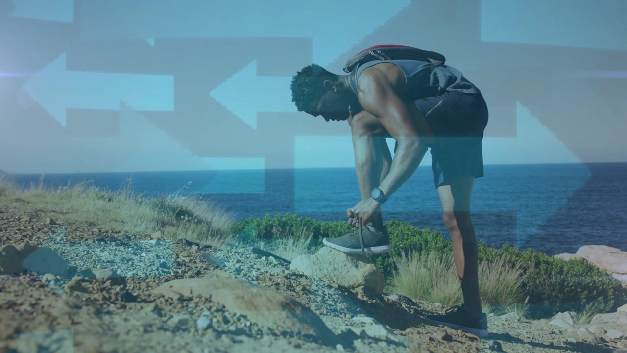 Male hiker stopping feeling loose lace, tying shoe for hiking, with blue arrows shifting over shoe
