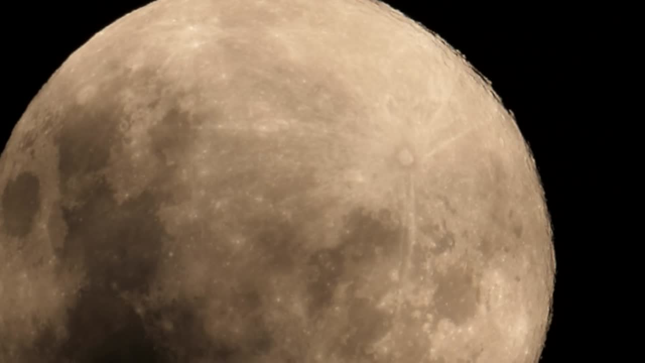 Close up of a spectacular pink full moon contrasted against a black night sky as viewed from South Africa on the 7th of April, 2020