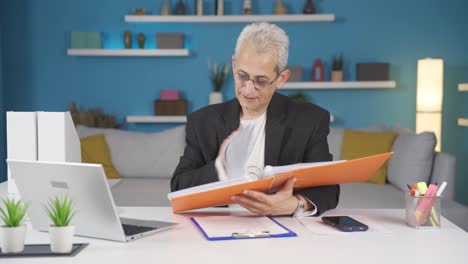 home office worker man looking at paperwork files.