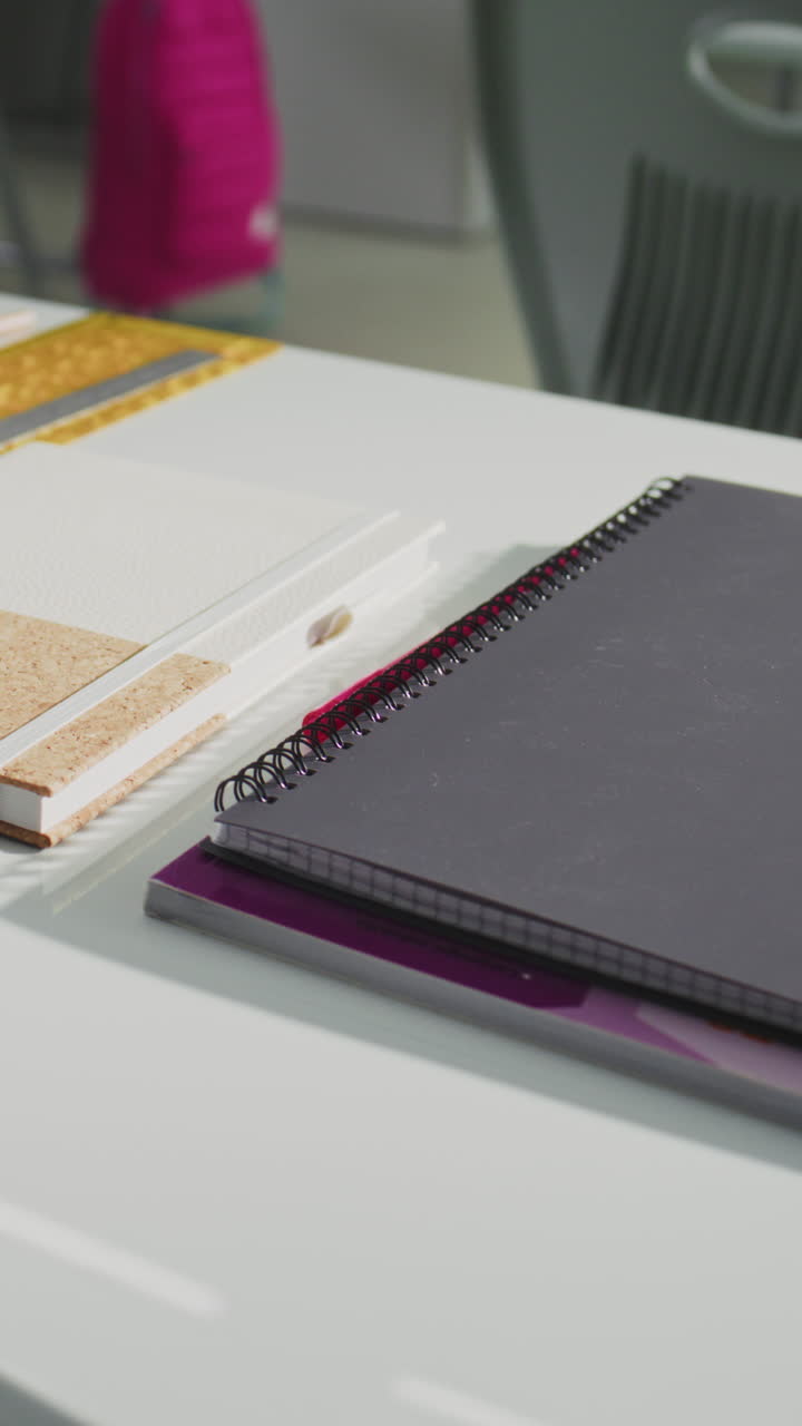 Close Up Shot of School Desk with Student School Supplies Pencil Case Pens and Pencils Notebooks