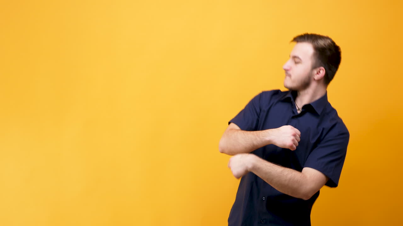 Man in blue shirt on yellow background
