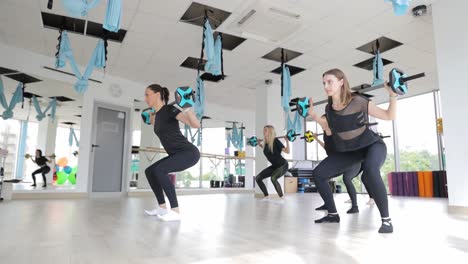 women in a fitness class with barbells