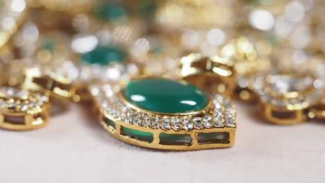 close-up of a gold necklace with green gemstone pendant