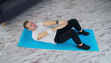strong male working out on quarantine. healthy lifestyle man training his body in home.