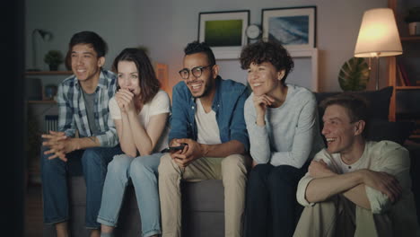 friends watching tv at home
