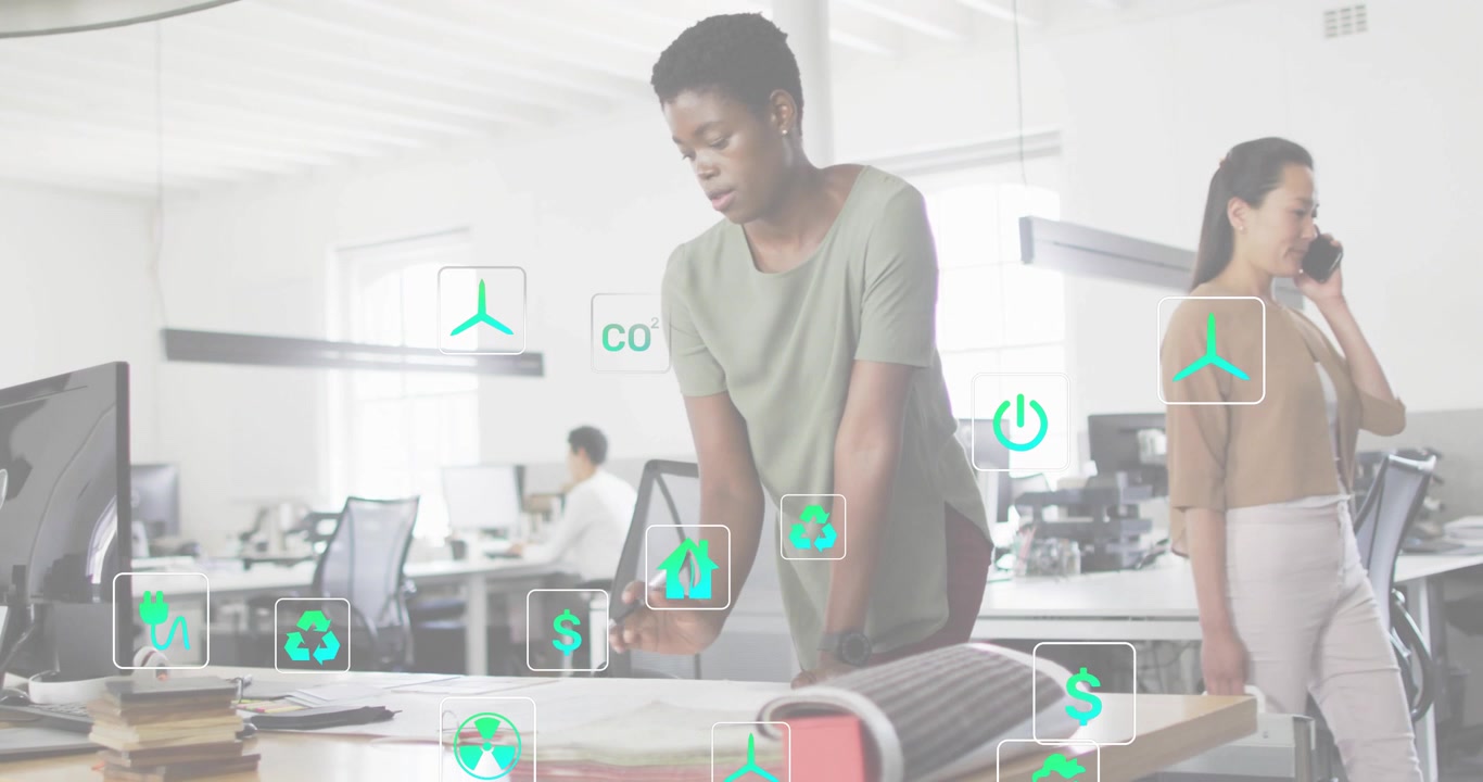 Camera focusing on blueprints, designer analyzing plans as coworker typing, eco icons appearing