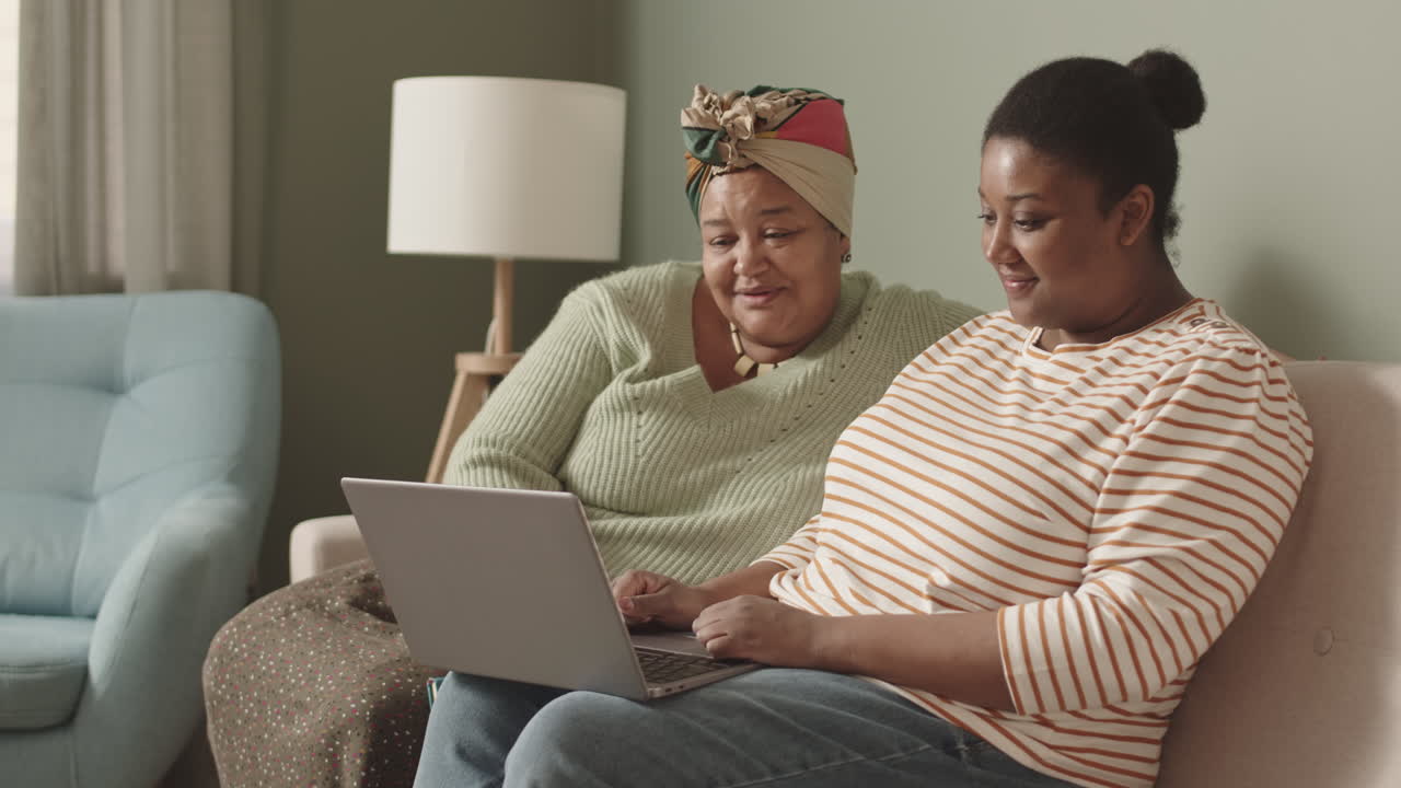 Two Women Using Laptop at Home