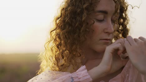 Curly-haired-girl-in-a-pink-dress-among-a-purple-field