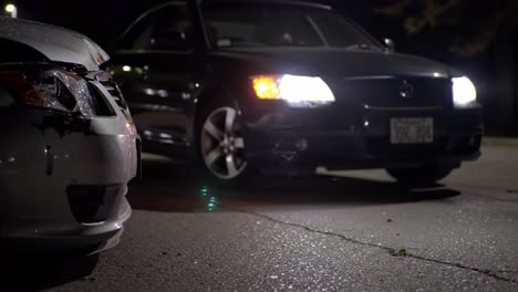 nighttime encounter: a dramatic close-up of two cars with a focus on one damaged vehicle, highlighting tension and intrigue in low-light conditions