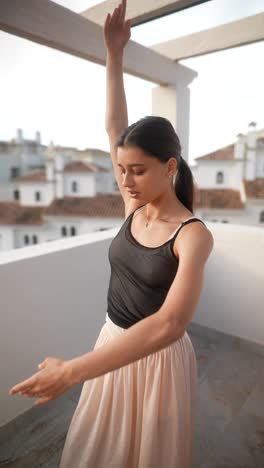 teenage ballerina posing on a rooftop