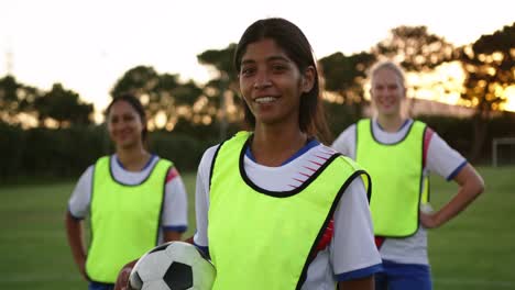 female soccer player standing on soccer field. 4k