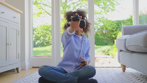 boy sitting on floor in lounge wearing vr headset playing driving computer game