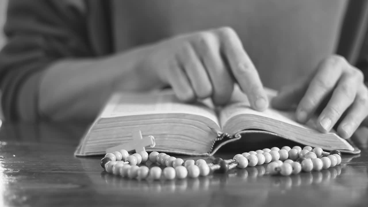 Woman Praying with Rosary and Bible