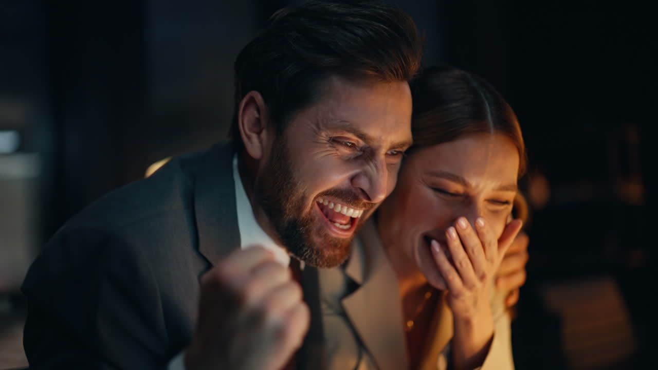 Overtime workers feeling excited rejoicing successful deal night office portrait
