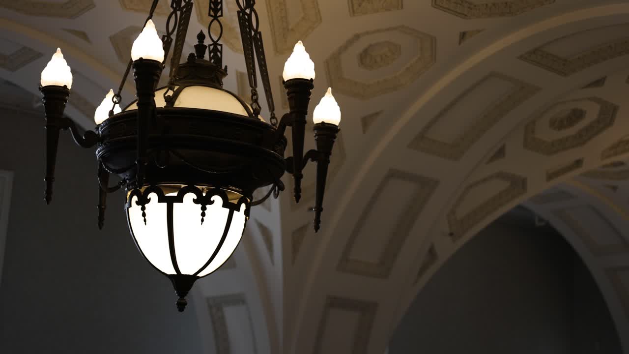 Chandelier lighting up a spacious arched hall