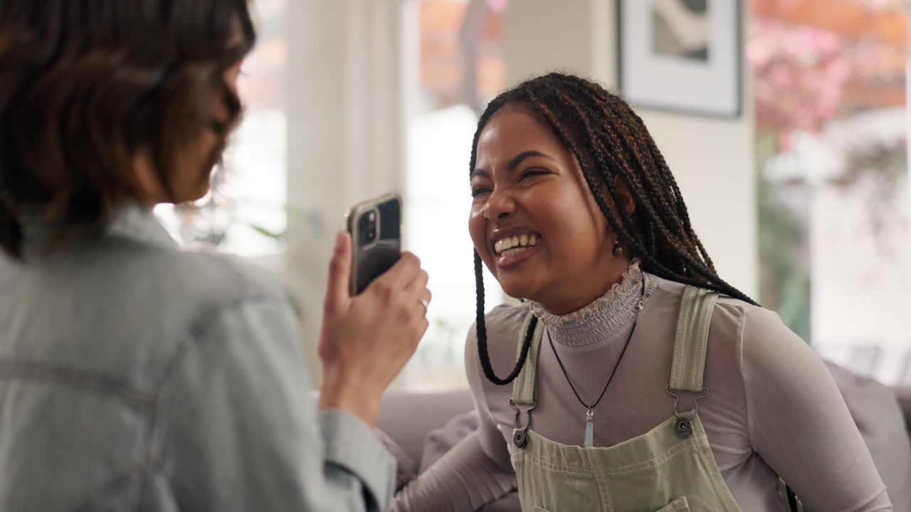 Two friends laughing and taking photos