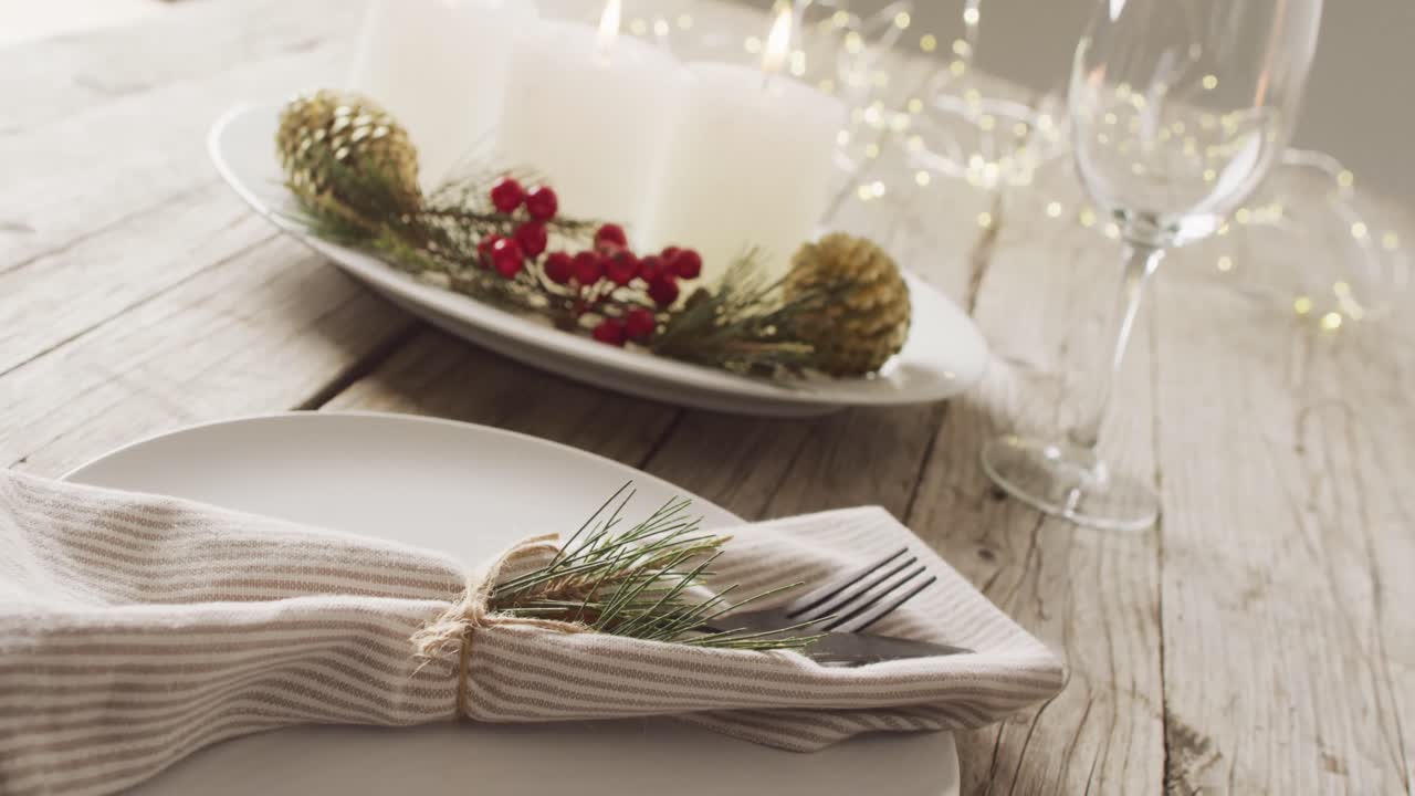 Video of christmas place setting with cutlery and candles on grey background