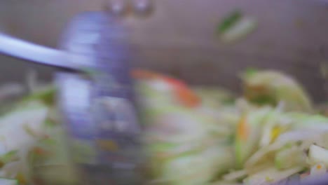 stirring a vegan sauté of vegetables. closeup