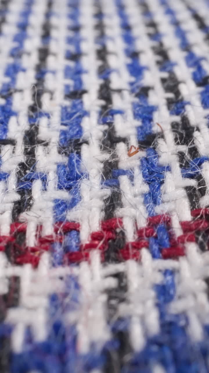 Colorful woolen plaid with pattern as background extreme close view. Elegant handmade blanket covering bed. Handicraft item for housekeeping