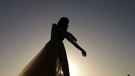 silhouette of girl dancing in sunset