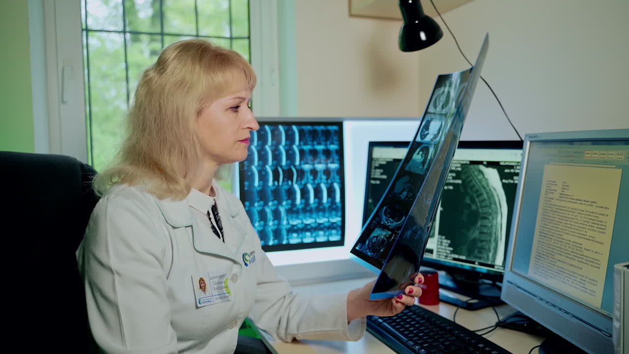 Female doctor looking at x-ray. Woman doctor looking at x-ray radiography