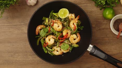 unrecognizable lady serving appetizing dish with shrimps with sesame seeds