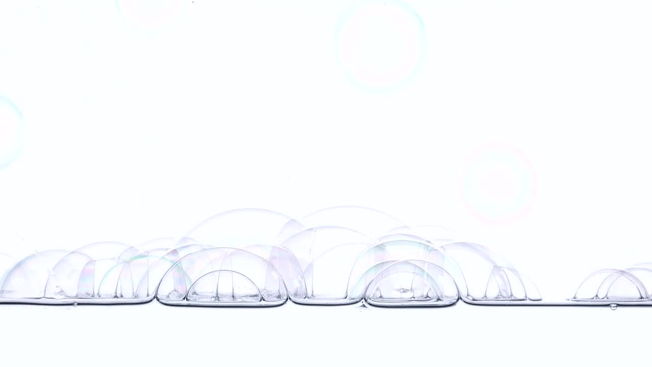 soap bubbles fall on the surface of the water 1