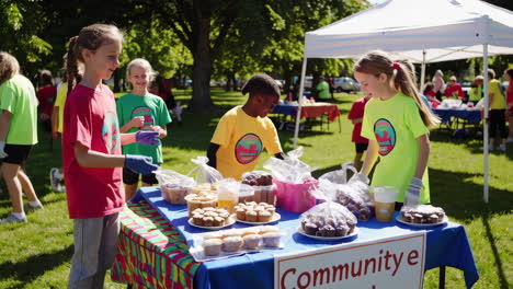 children selling baked goods at an outdoor community event