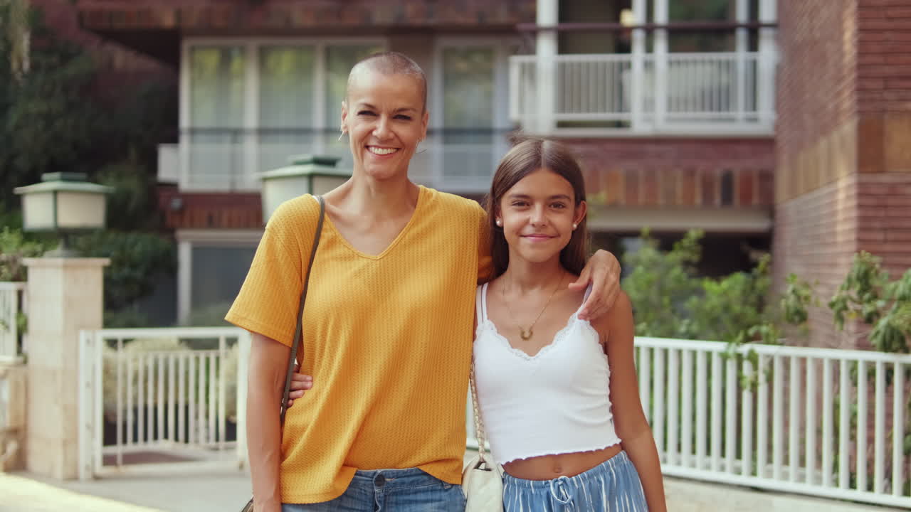 Mother and Daughter Embrace on a City Street