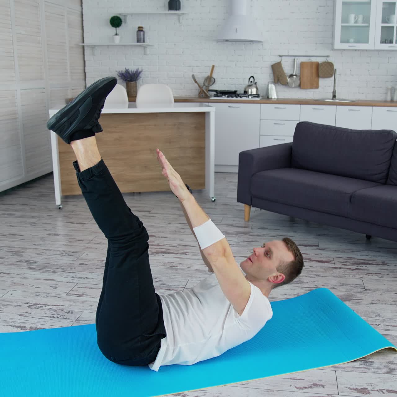 Handsome man training indoor. Lifestyle athlete body man working out in home