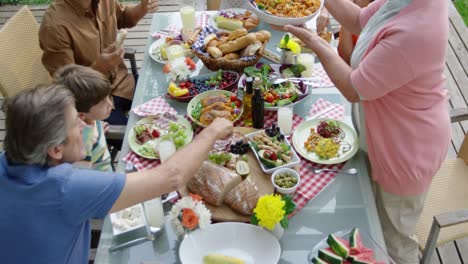 family eating outside together in summer