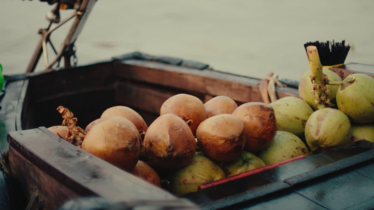 Fresh coconuts on a wooden boat in Vietnam, perfect for a tropical lifestyle shot