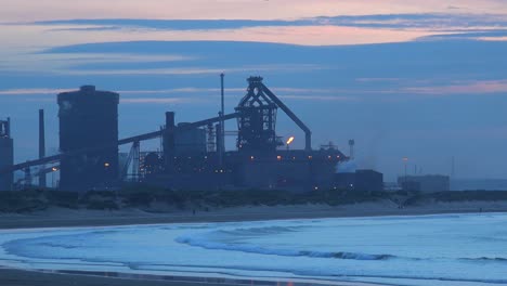 A-power-plant-at-dusk-along-a-beach-in-England