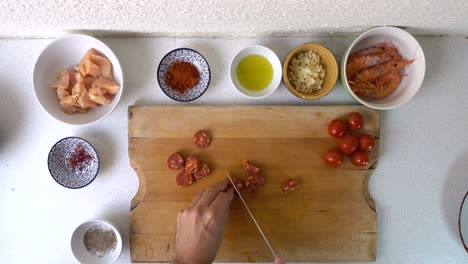 top down tasty style video of male hands cutting chorizo into pieces