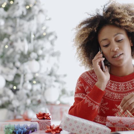 young woman wrapping gifts at christmas