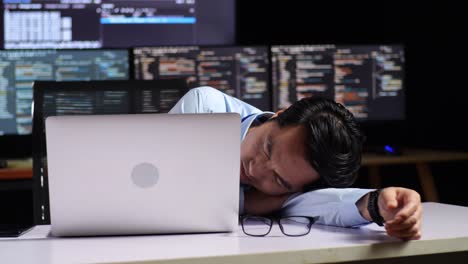 tired programmer taking a nap at his desk